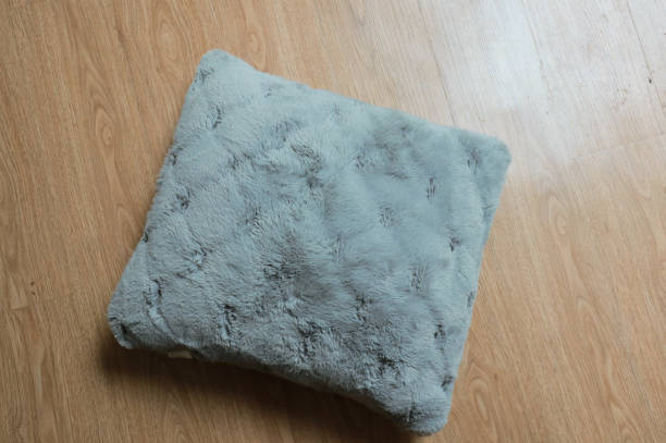 istock Grey soft pillow on wooden background 2153397057