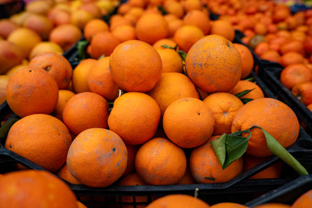 istock Fresh oranges in the plastic crate at the market. 2153397371