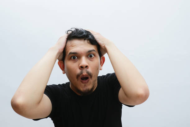 istock portrait shocked expression of asian man 2153398529