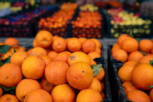 istock Fresh oranges in plastic containers at the market. 2153399141