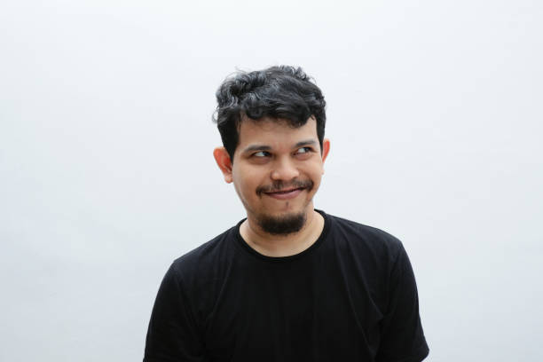 istock a smiling asian man with a funny face 2153399530