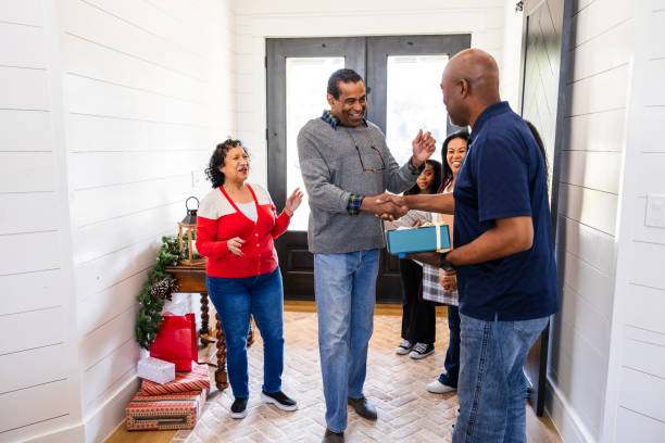 istock Arriving for Christmas, senior dad shakes son's hand 2153399717