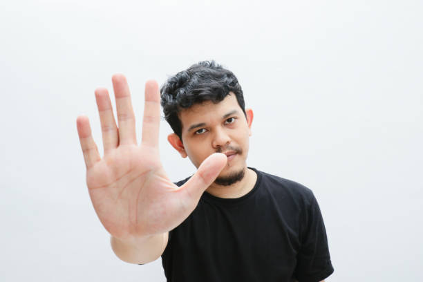 istock an asian man shows a refusing gesture or a no sign 2153399833