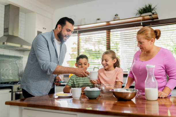 istock Family cooking at kitchen 2153401011