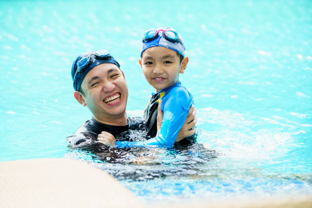 istock Father and son swimming together. 2153401080
