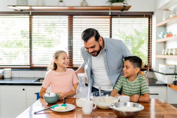 istock Father cooking with daughter and son at home 2153401172