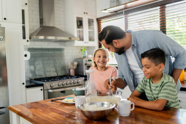 istock Father cooking with daughter and son at home 2153401197