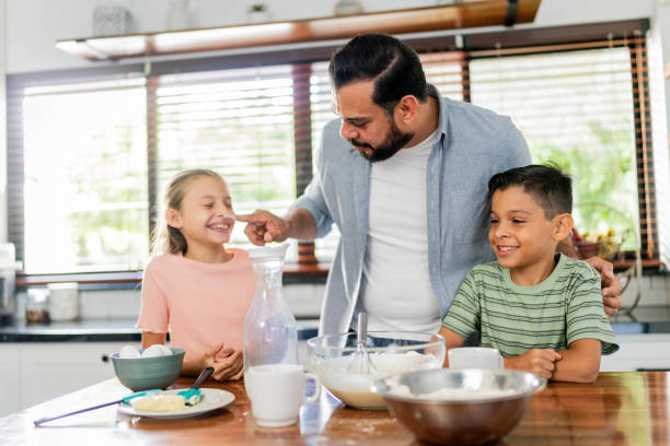 istock Father cooking with daughter and son at home 2153401202