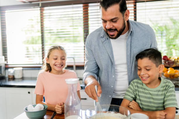 istock Father cooking with daughter and son at home 2153401206