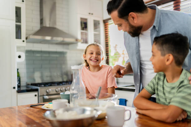 istock Father cooking with daughter and son at home 2153401211