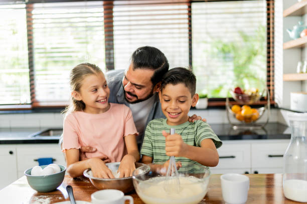 istock Father cooking with daughter and son at home 2153401240