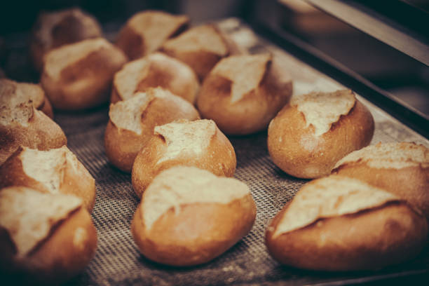 Freshly baked buns on the baking tray in a bakery.