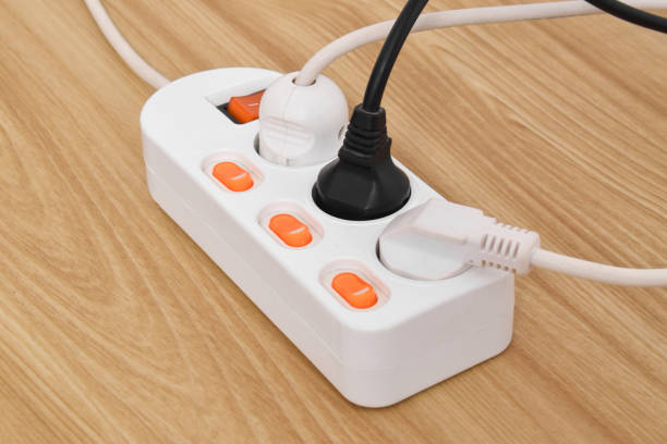 istock Electrical plug in outlet socket at home isolated on on wooden table 2153407498