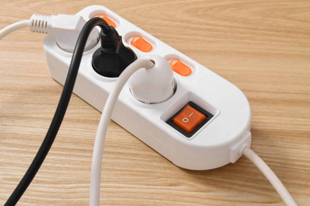 istock Electrical plug in outlet socket at home isolated on on wooden table 2153407537