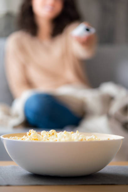 istock Popcorn at the table whit woman in background 2153407856