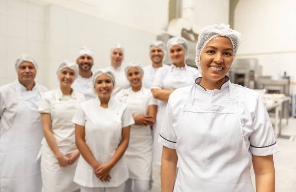 istock Woman leading a group of workers at a food processing plant 2153409124