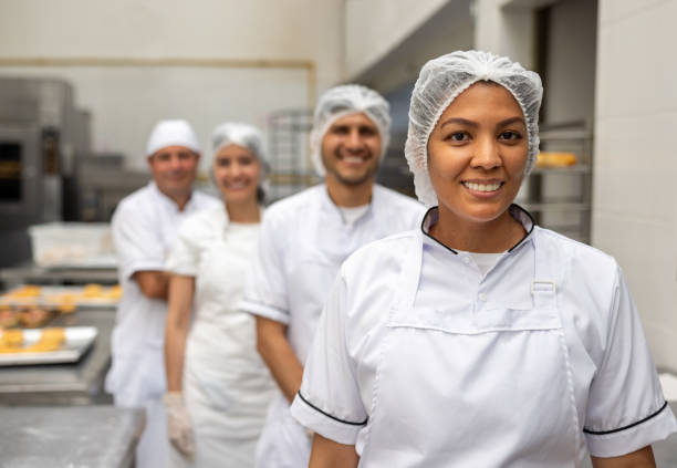 istock Employees working at a donut factory 2153409145