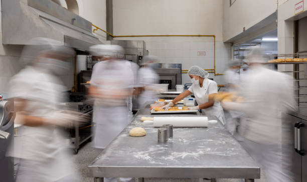 Employee working at a busy donut factory