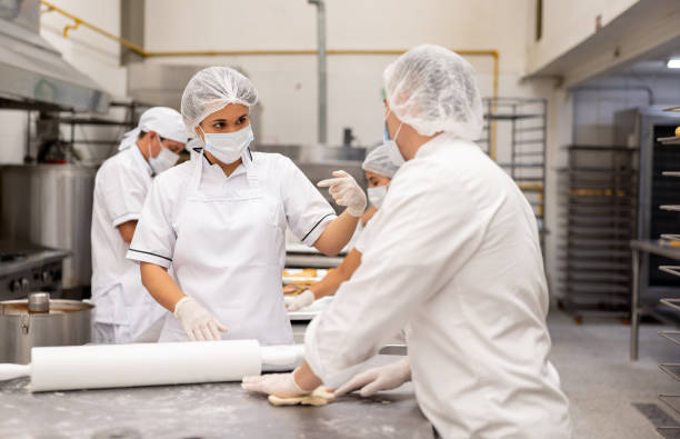 istock New employee in training while working at an industrial bakery 2153409194