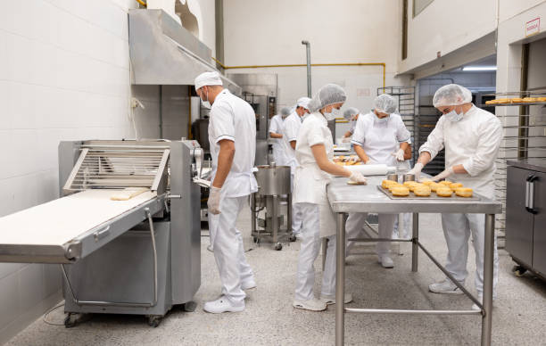 istock Group of workers working at an industrial bakery 2153409209