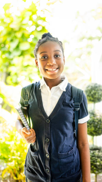 istock Cute young African American elementary school student ready for school stands outside on the first day 2153413902