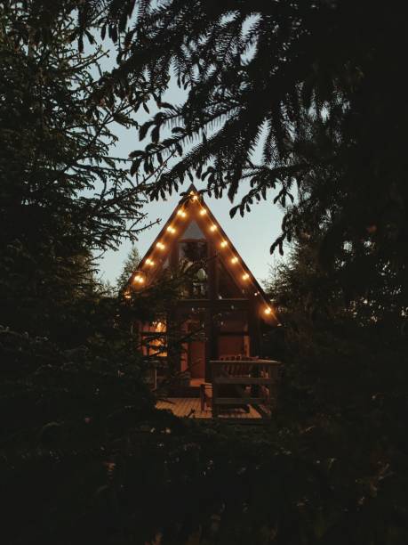 istock Wooden bungalow house a frame with light bulbs 2153415736