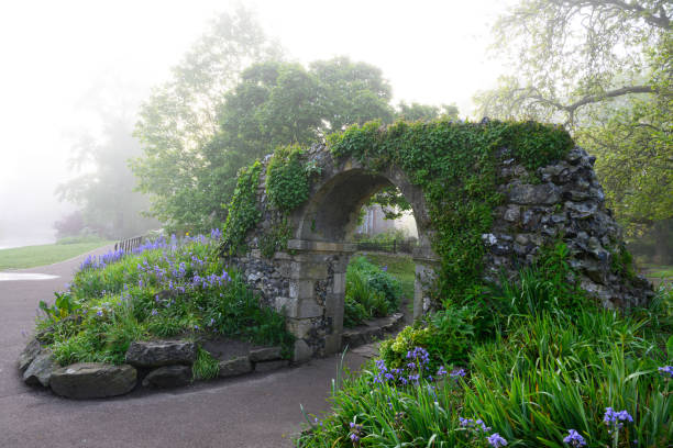 Rail track tunnel with castle looking house on top, in a green hill, East Sussex, UK