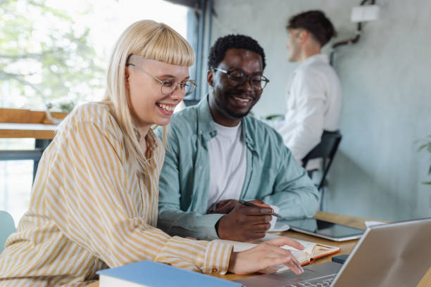 istock Young people working together on laptop in co-working space 2153416568