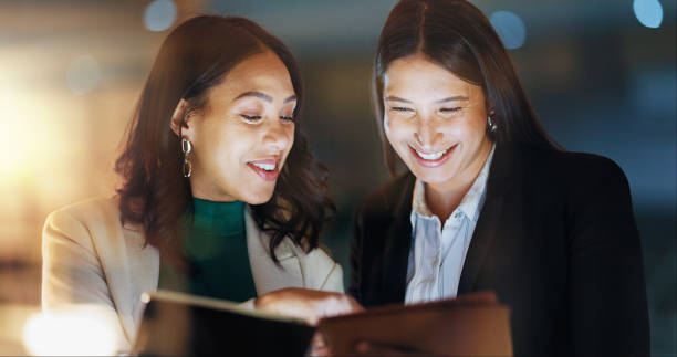 istock Night, business and women with a tablet, high five and cooperation with connection, support and website information. People, employee or consultant with tech, evening or agreement with partnership 2153419226