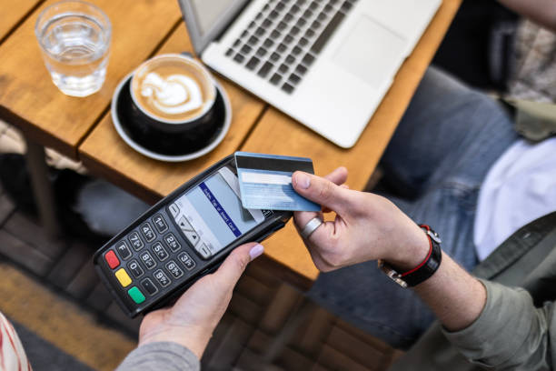istock Smart casual young guy is paying with credit card 2153419814
