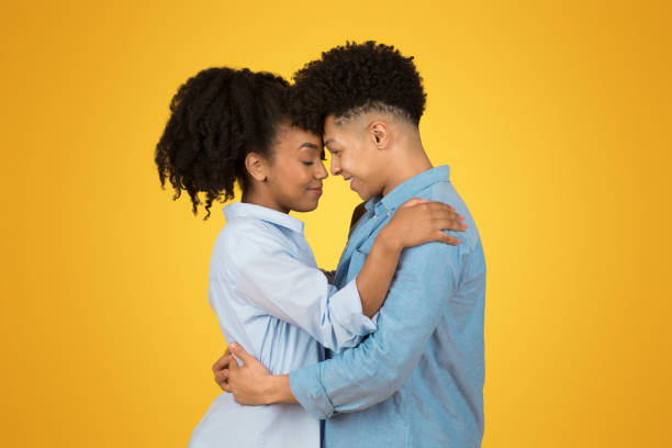 istock An intimate moment between two young individuals with eyes closed and heads touching 2153424669