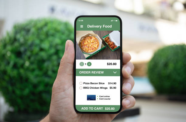 istock Man hand holding phone with food delivery app on screen 2153426008