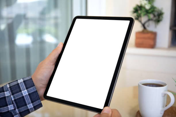istock male hands holding computer tablet with isolated screen in home 2153426547