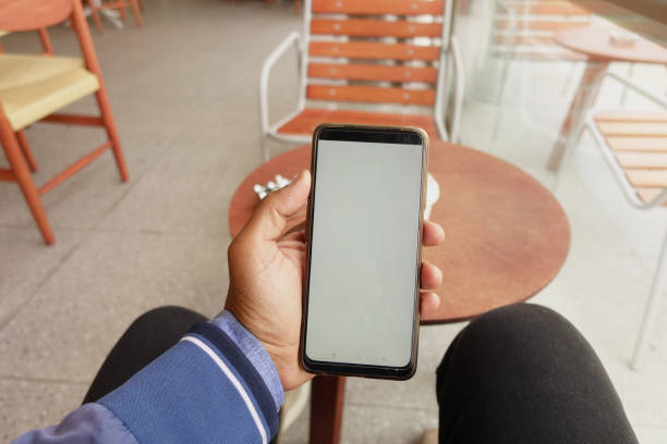 istock young man hand using smart phone with green screen at cafe 2153427486