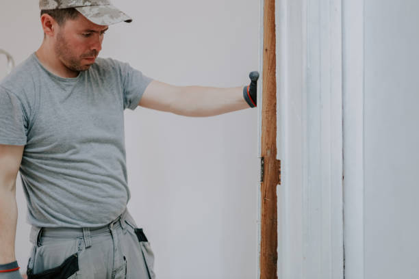 istock A young man dismantles old skirting boards. 2153428656