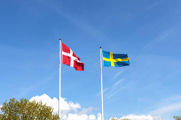 istock Denmark and Sweden flags against blue sky 2153432882