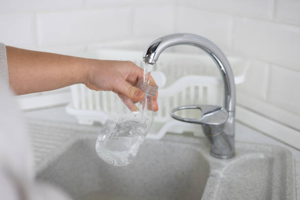 istock Rinsing a plastic bottle under water while collecting plastic for recycling. Sorting waste at home to be sent for recycling. Ecology concept, plastic sorting. 2153433061