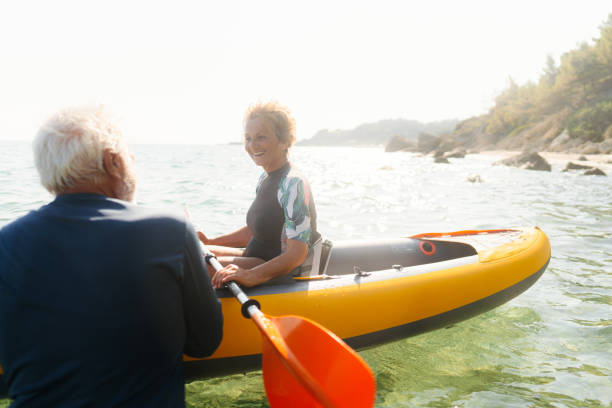 istock Senior couple kayaking at sunset 2153435216