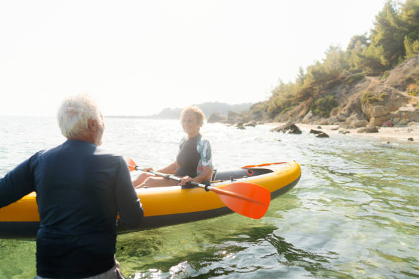 istock Senior couple kayaking at sunset 2153435222