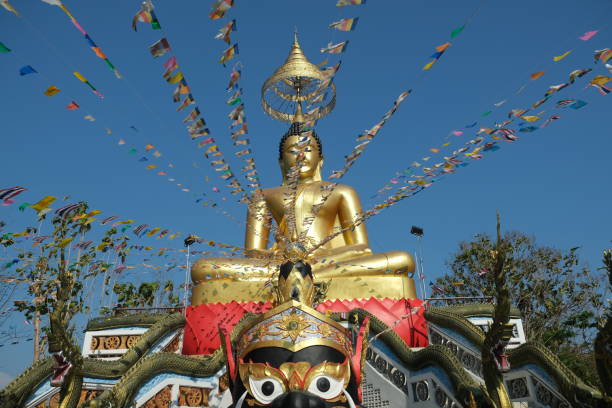 istock big golden buddha and flags 2153436914