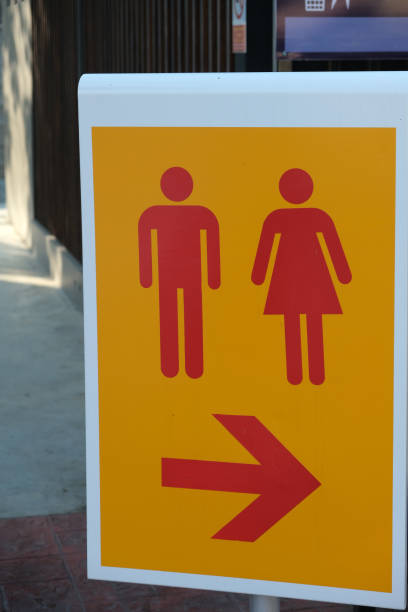 istock yellow sign with red toilet direction arrow 2153436940