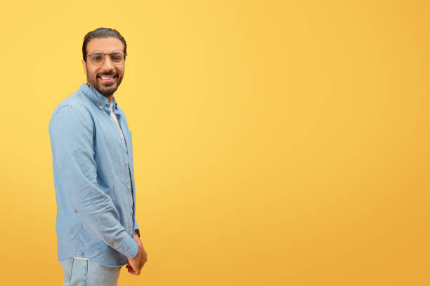 istock Man in denim smiling and standing confidently 2153437799