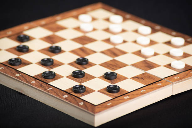 istock Checkerboard with light and dark pieces. Game concept. Board game. Hobby. Checkers on the playing field for a game 2153444838