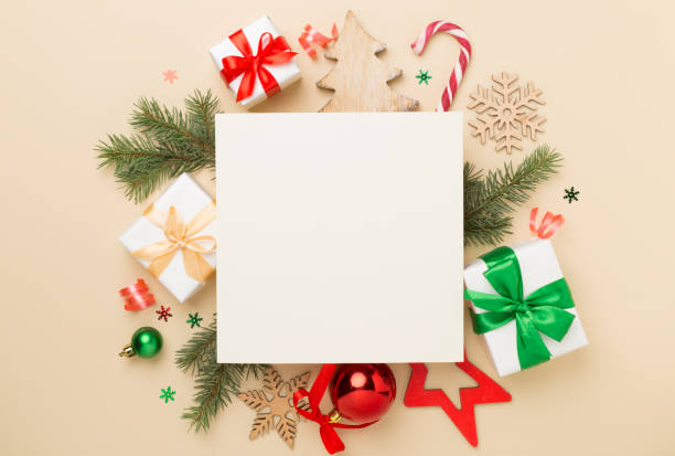istock Greeting card mockup with christmas decor on color background, top view 2153445062