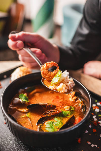 istock man eating thai tom yum soup in a restaurant 2153445508