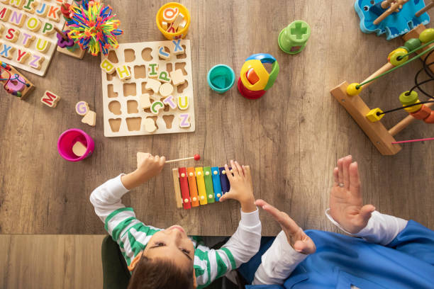 istock Nurse and Boy Play Metallophone 2153446409