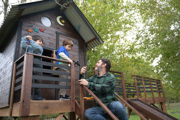 istock father playing with children in tree house 2153447012