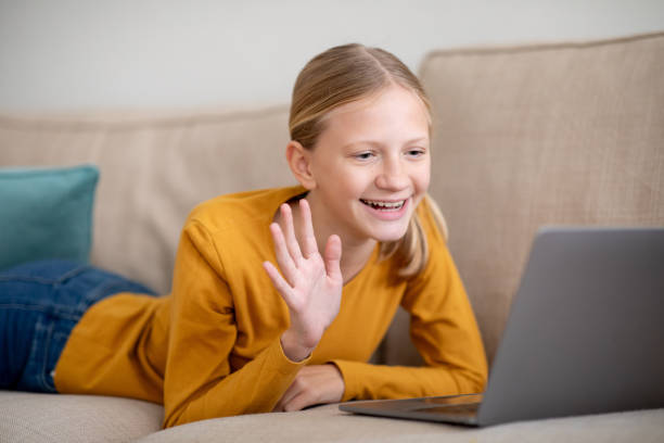istock Young Girl Using Laptop on Couch For Video Call 2153447078