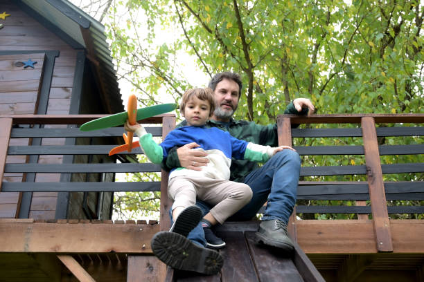 istock father playing with his son in tree house 2153447155