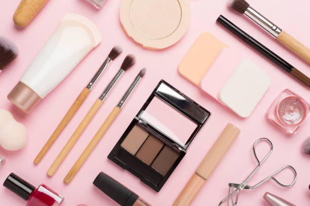 istock Flat lay with makeup products and tools on color background 2153447385